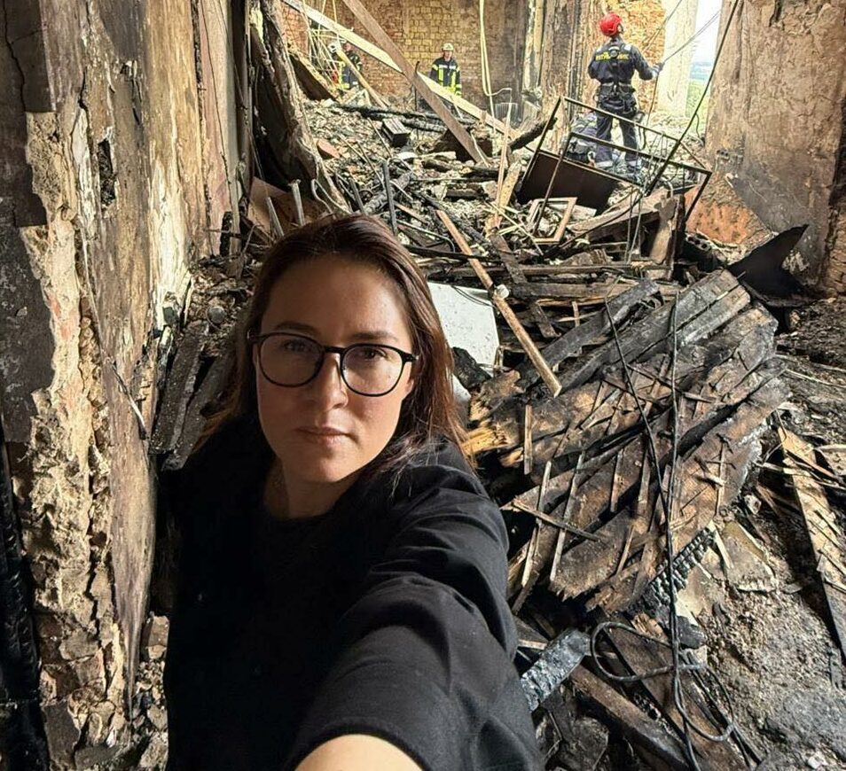 Prime Minister Yulia Svyrydenko, standing amid the rubble